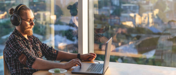 istock A young man works on a laptop. Remote work using a laptop. 2174918535