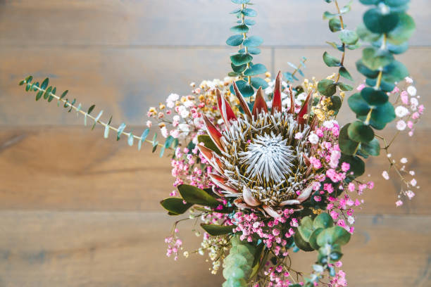 istock Top view a beautifully balanced floral arrangement, centered around a King Protea with striking spiky petals 2174918851