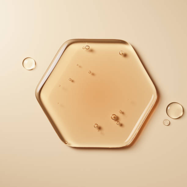 Hexagon-shaped pool of amber liquid, featuring smooth, glossy texture and small bubbles. Skincare or oil-based beauty products with natural, nourishing ingredients. 3d rendering cosmetic concept.