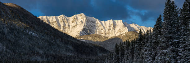 istock Sun shining on fresh snow covering rugged mountain peaks 2174920137