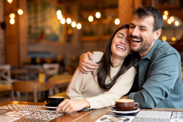 istock Happy embraced couple smiling while enjoying coffee in cafeteria 2174922193
