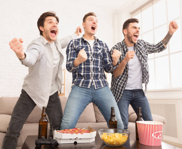 istock Wow, goal. Guys watching match and celebrating victory 2174923810