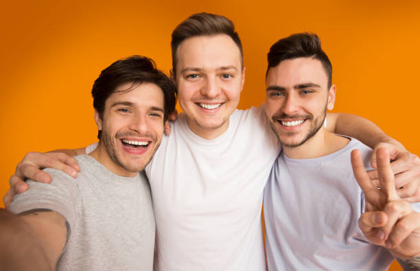 istock Portrait of cheerful guys making selfie, having fun 2174923827