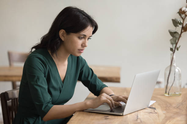istock Focused woman use laptop, read e-mail, prepare report, studying online 2174923976