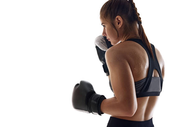 istock Side view image of sweating, focused young woman, boxing athlete in globes,. practicing isolated on white studio background 2174924407