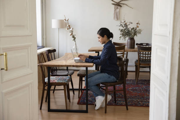 istock Serious woman sit at table use laptop communicate with clients 2174925564