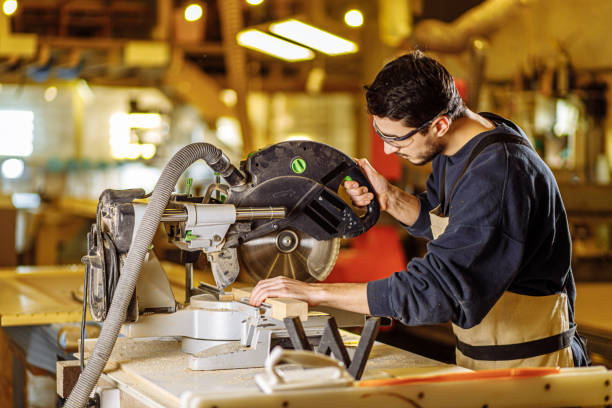 istock carpenter work with mitre saw in factory 2174926676