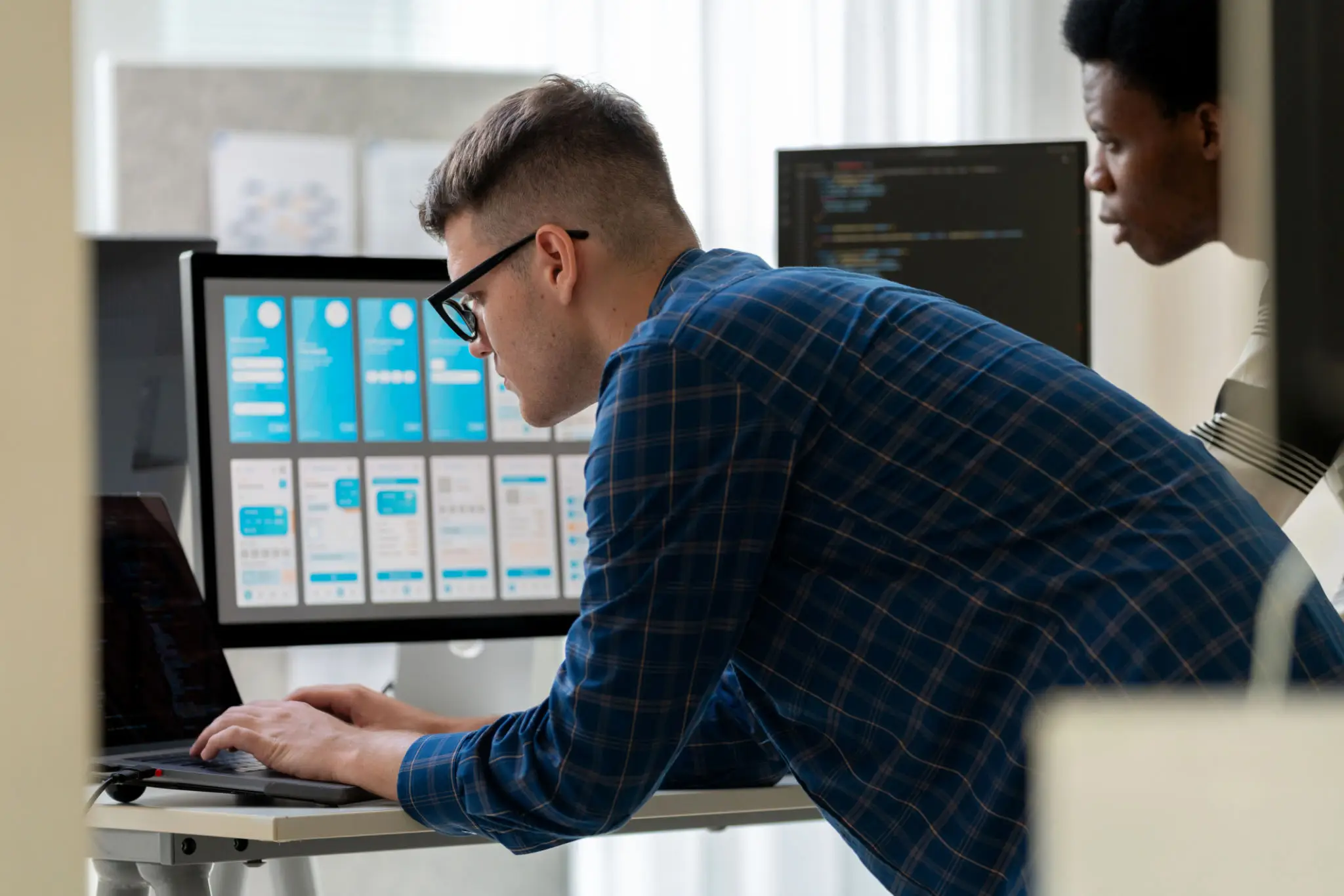 Both of IT professionals working together in an office setting, solving digital problems related to cybersecurity, software development, and coding. The team is engaged in programming and troubleshooting HTML code, focusing on data science, security.