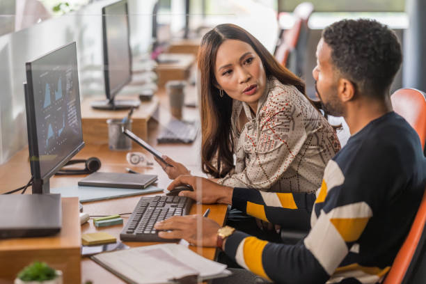 istock Asian Businesswoman and Colleague Analyzing Data in Office 2174927333