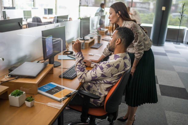 istock Asian Businesswoman and Colleague Analyzing Data on Computer in Office 2174927342