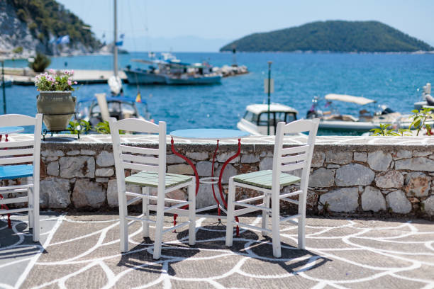 istock White chairs and a blue table overlooking a sunny harbor in Greece 2174927567