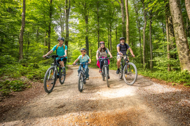 istock Caucasian Family Cycling in Forest 2174928392