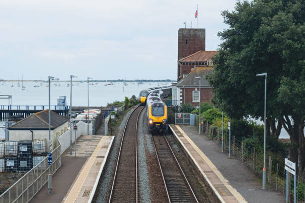 istock One train arriving at a railway station shortly after another has departed 2174928580