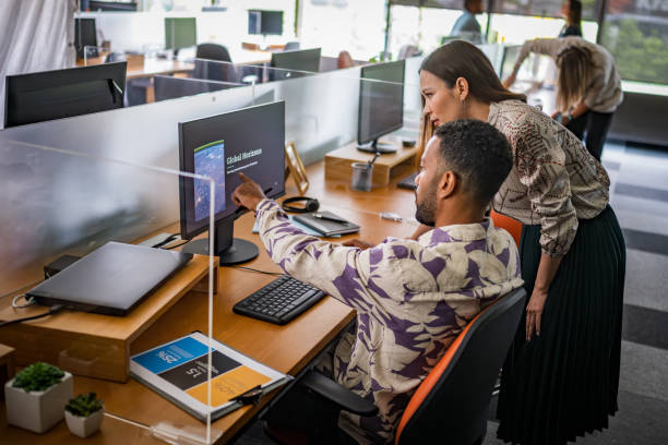 istock Asian Businesswoman and Colleague Analyzing Data on Computer in Office 2174928937
