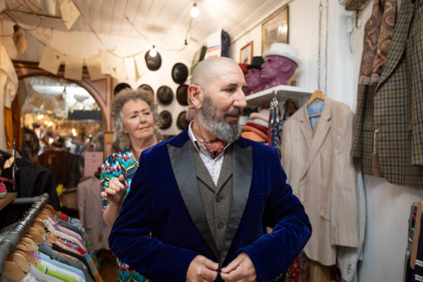 istock Senior man trying on a jacket in a vintage clothes store 2174933864