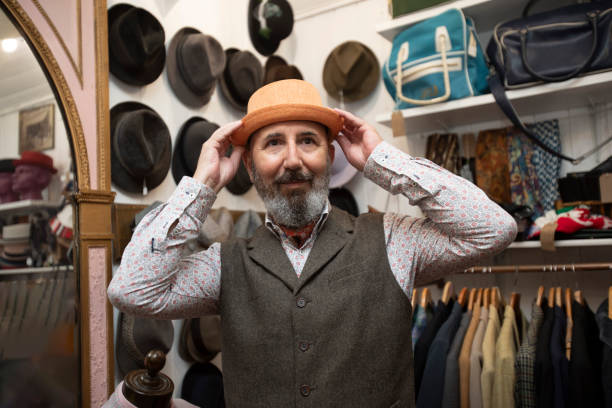 Senior man shopping for vintage clothes in a store in Brighton, England.