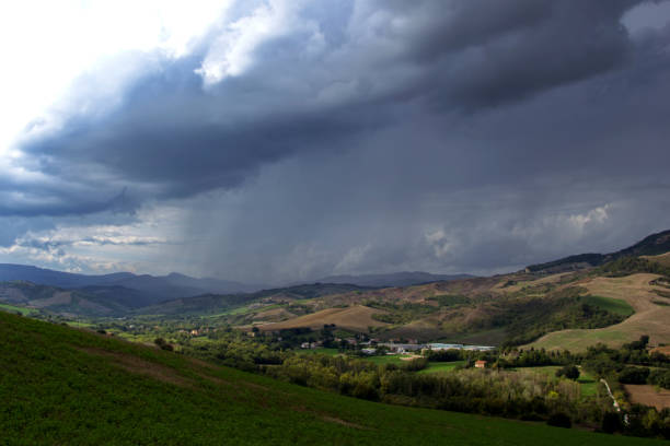 storm cloud with virga over a Montefeltro valley