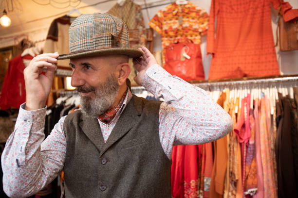 Senior man shopping for vintage clothes in a store in Brighton, England.