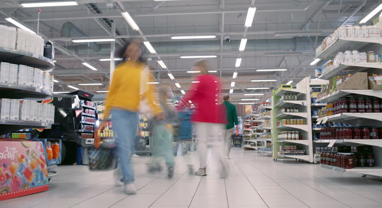 Timelapse of Diverse Shoppers Navigating a Supermarket, Selecting Items From Stacked Shelves. People of Various Races and Genders Move Quickly Through the Aisles, Creating Dynamic Shopping Footage