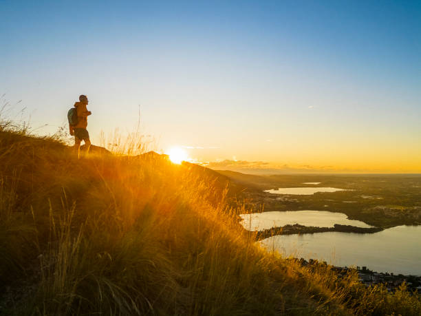 istock Hiker on top of hill during sunset 2174943444