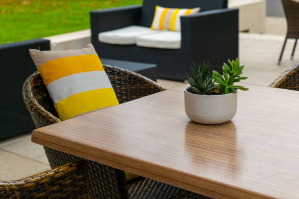 istock table with a potted plant on it and a yellow pillow on a chair 2174947033