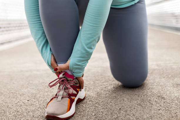istock Young woman on bridge having ankle injury 2174947126
