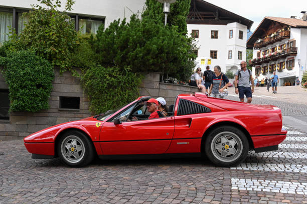 A red Ferrari 328 GTS from 1988 in the streets of Schenna, South Tyrol.