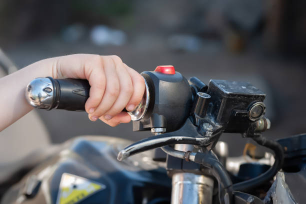 istock A boy holds the steering wheel of a motorcycle 2174960805