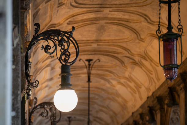Vintage outdoor lamps. Vintage lights in an old arch gallery. Arched passage in the evening.