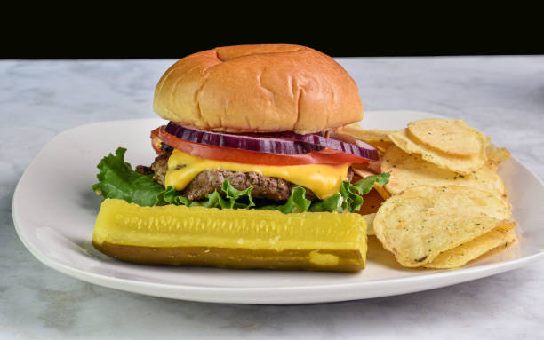 istock cheese burger with potato chips and pickle 2174986041