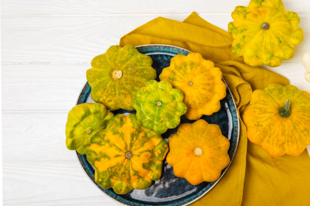 istock Pattypan zucchini on a textured kitchen table. squash. Fresh organic pattypan squashes on background. Vegan. Farmer's Market. Patisson. Space for text. Copy space. 2174988807