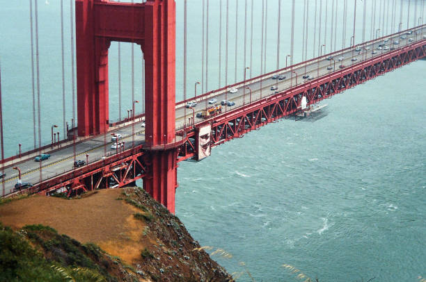 Golden Gate Bridge and San Francisco in the background under a cloudy sky.Taken at Marin Headlands, California, USA.