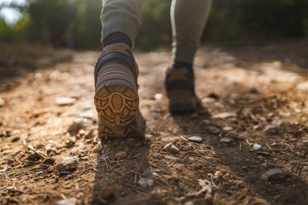 istock Close up of a unknown man hiking on a dirt path with rocky terrain 2175001821