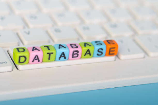 the word DATABASE spelled out in colorful letter blocks on a computer keyboard, symbolizing the concept of data storage and management.
