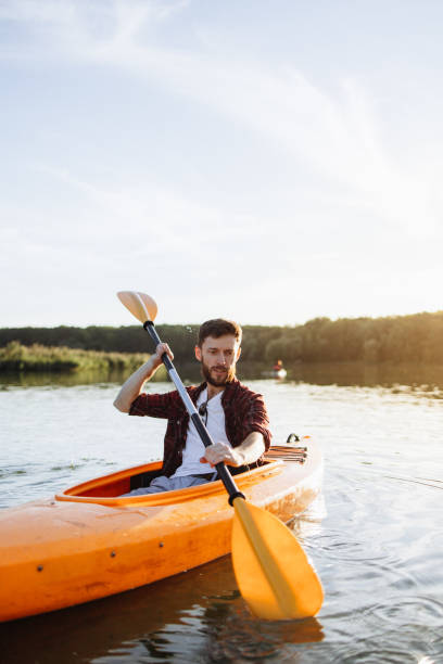 istock Confident Handsome Man Rowing Kayak at Sunset 2175012685