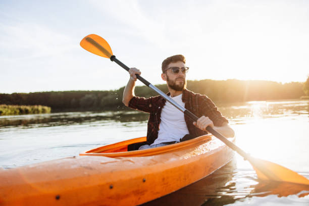 istock Confident Handsome Man Rowing Kayak at Sunset 2175012830
