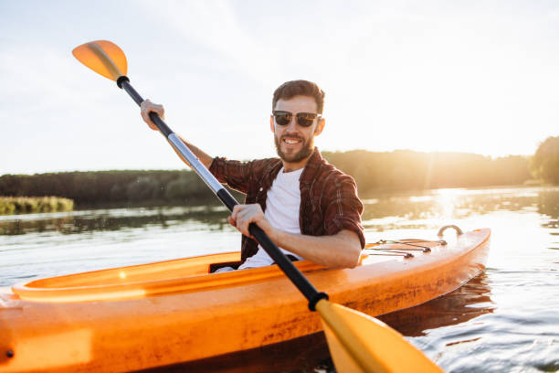 istock Cheerful Handsome Man Rowing Kayak at Sunset 2175012871