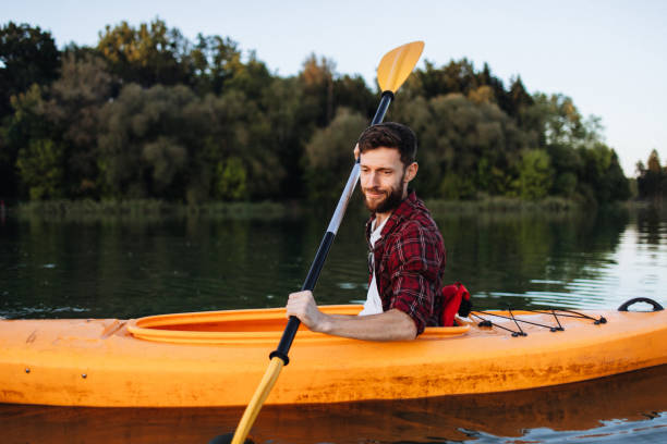 istock Confident Handsome Man Rowing Kayak at Sunset 2175013531