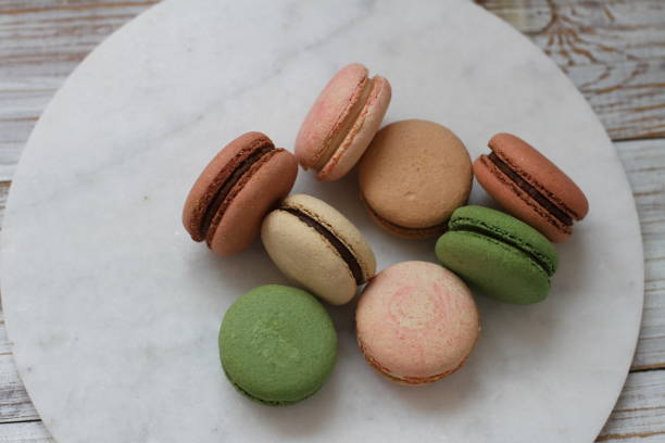 istock Macarons on the marble plate on the wooden background 2175014146