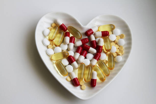 istock Capsules and vitamins on the white plate 2175017983
