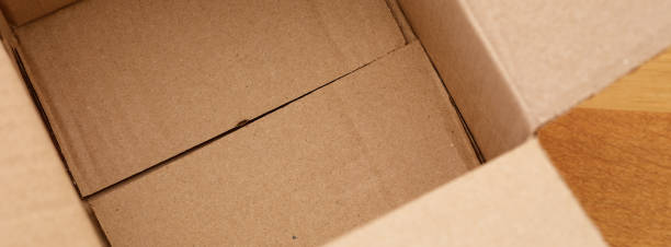 istock Empty cardboard box a wooden floor 2175023143