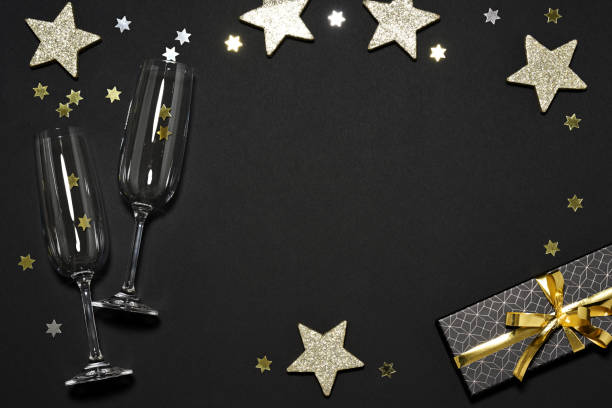 istock Two flutes with gift and shiny stars 2175023873