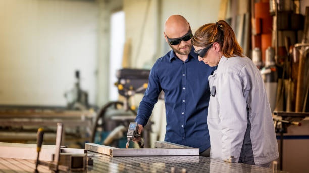 istock Skilled Welder Guides Apprentice in Metalwork 2175028291