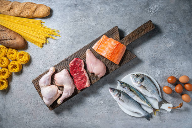 istock Healthy protein source food meat, eggs and fish and carbohydrates on a cutting board 2175030950