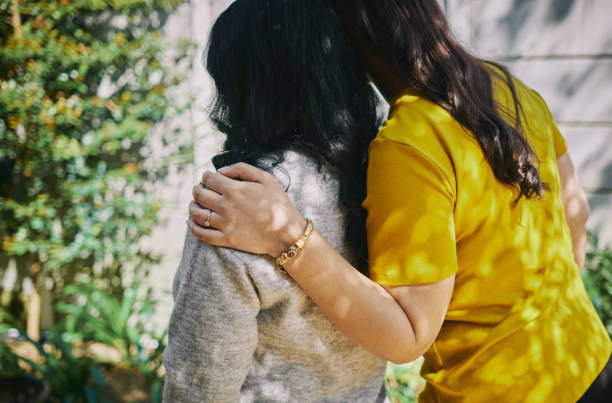istock Mother and Daughter Embracing from Behind 2175032013