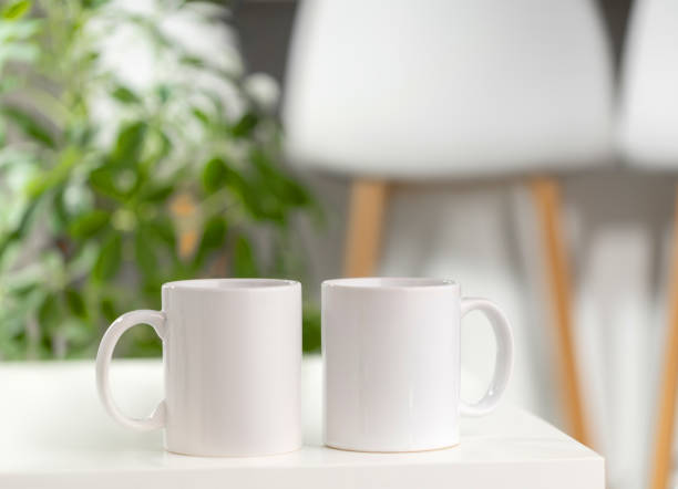 istock Mockup of a white tea cup or coffee mug on a white table in a Scandinavian style kitchen 2175032172