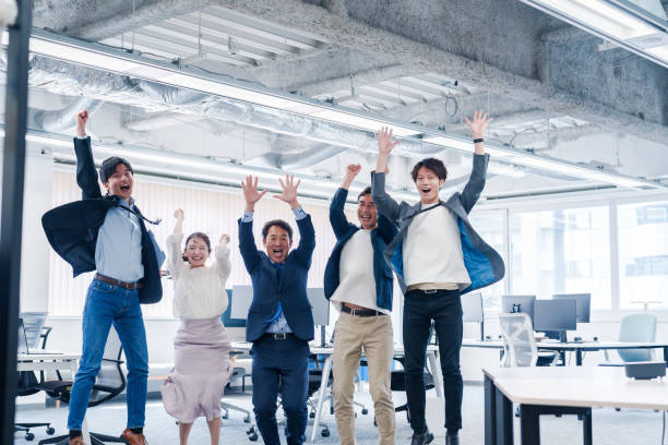 istock Business people jumping for joy in the office. 2175034543