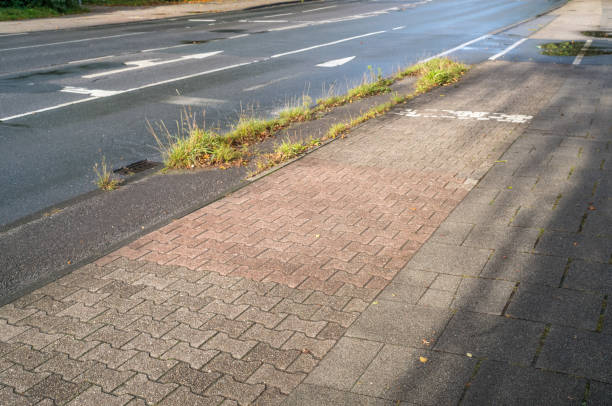 istock wet road with cycle path and sidewalk, poorly maintained 2175034735