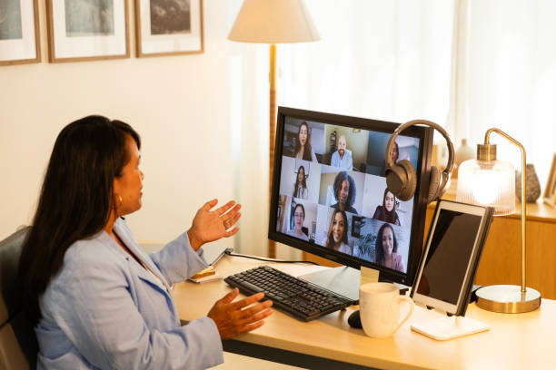 istock Mid adult female gestures while talking to her classmates about their project 2175035111