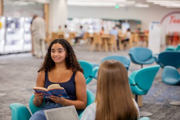 istock College students meet to study for exams together in campus library common area 2175035805